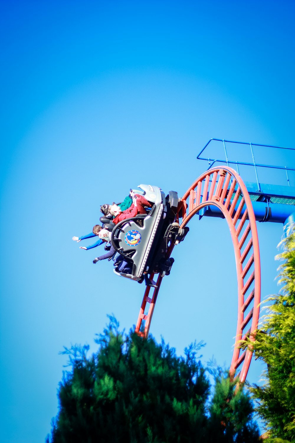 a person riding a roller coaster on a clear day