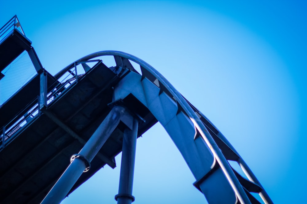 a roller coaster with a blue sky in the background