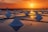 the sun is setting over a large salt farm