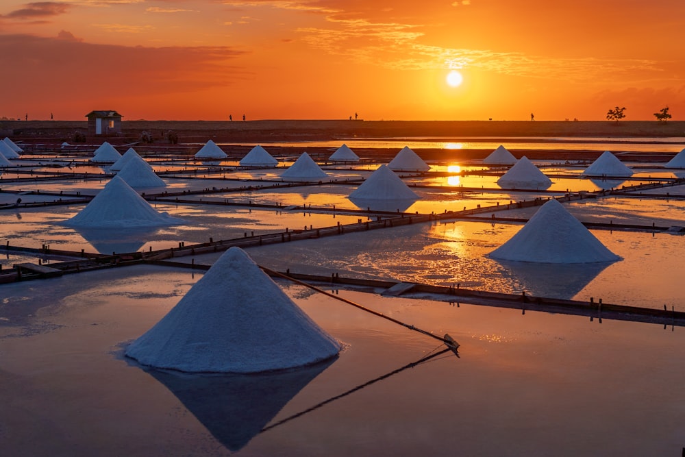 the sun is setting over a large salt farm
