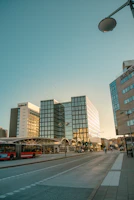 A bustling Edinburgh street with modern office buildings housing tech startups.
