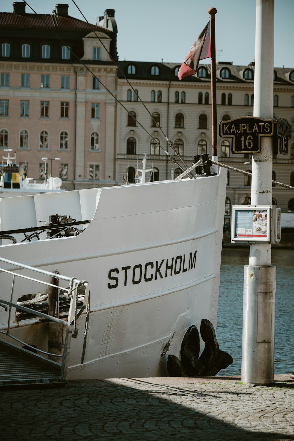 a large white boat sitting next to a dock