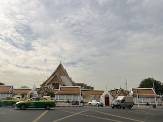 Taxi parked near the Haridwar temple with mountains in the background.