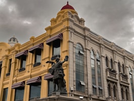 a building with a statue of a man on a horse in front of it
