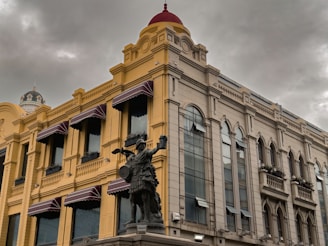 a building with a statue of a man on a horse in front of it