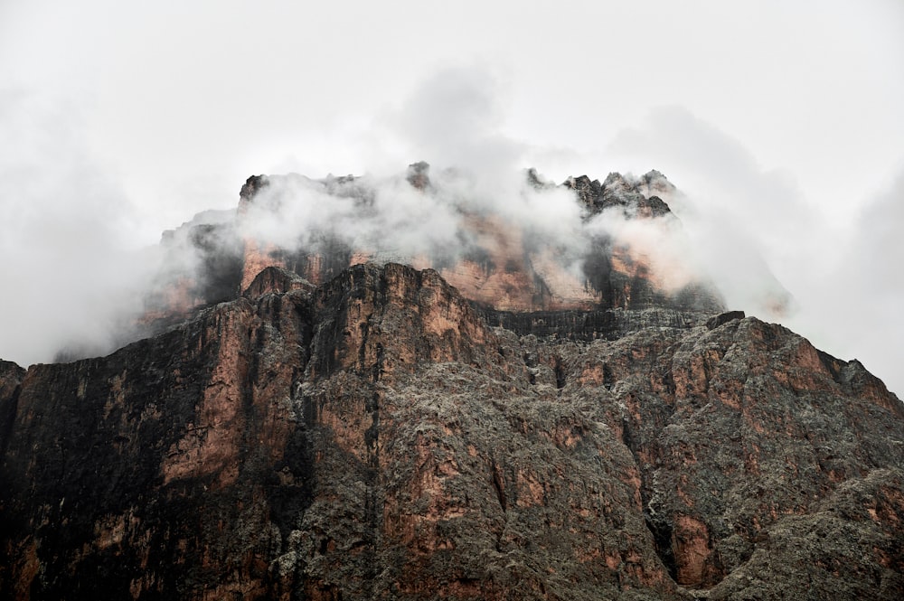 a very tall mountain with some clouds coming out of it