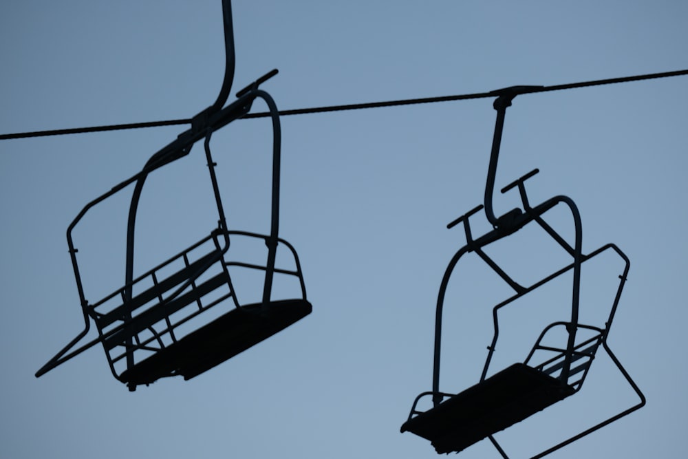 a couple of chairs hanging from a wire