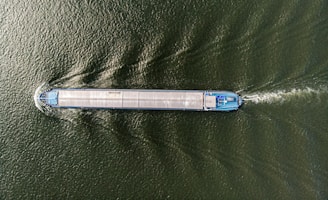 an aerial view of a boat in a body of water