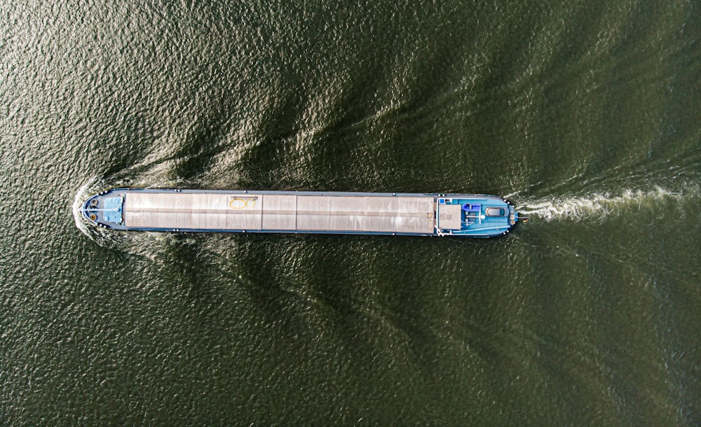 an aerial view of a boat in a body of water