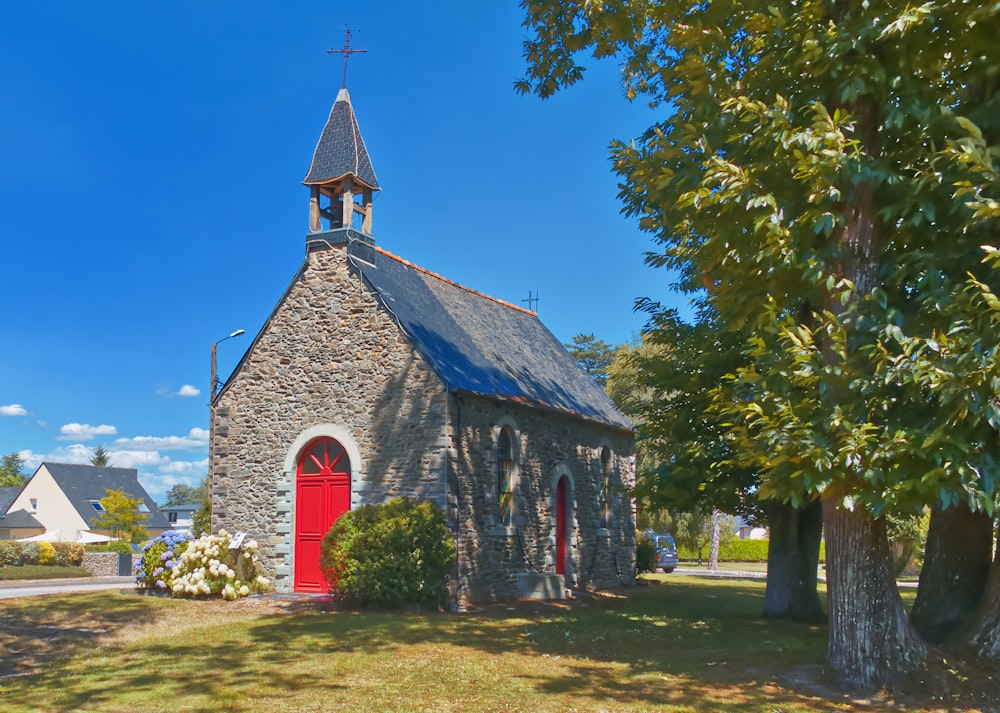 a church with a red door and a steeple