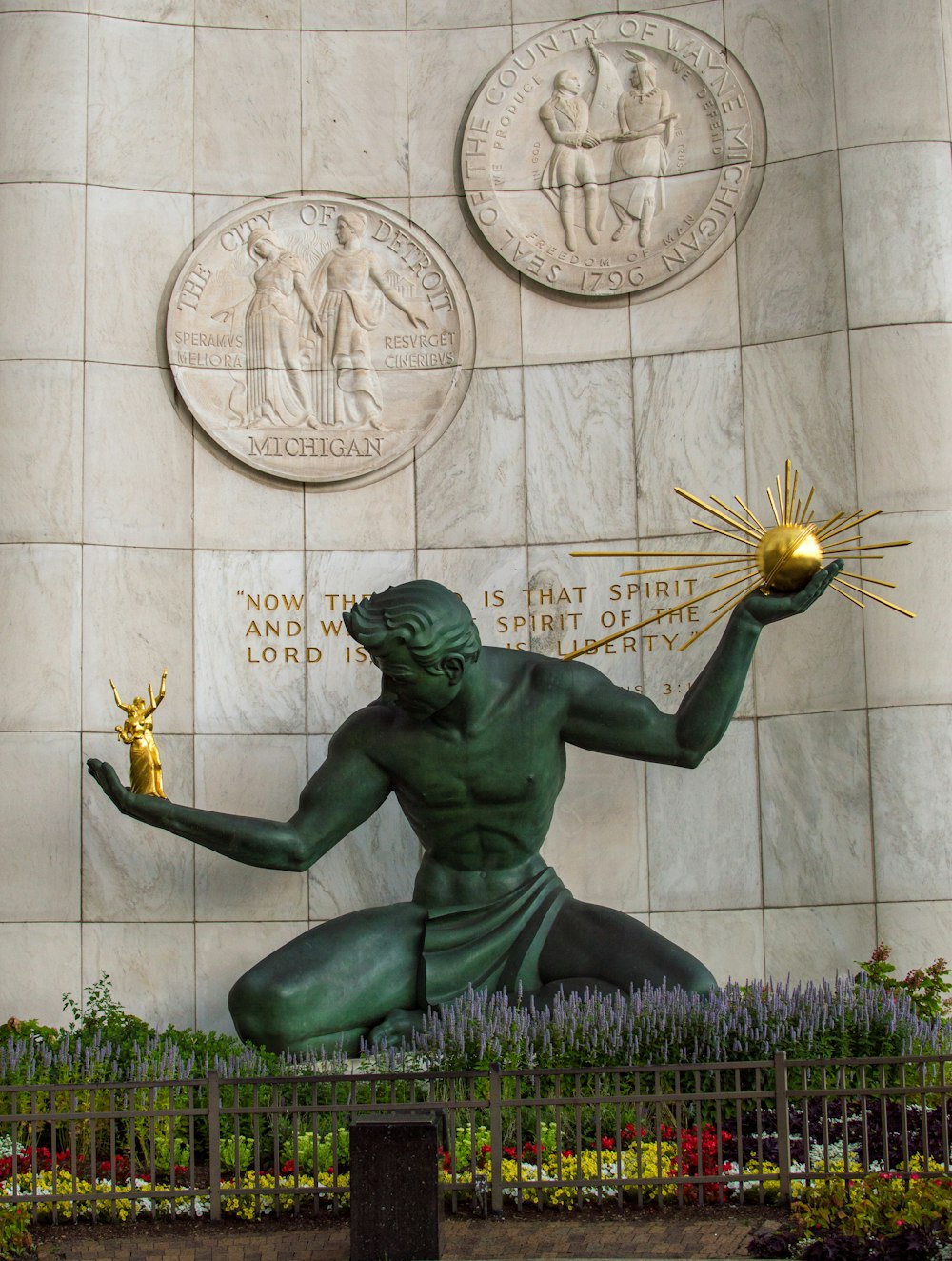 a statue of a man holding a golden ball