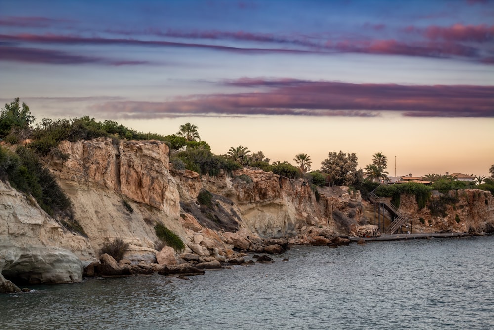 a body of water near a rocky cliff