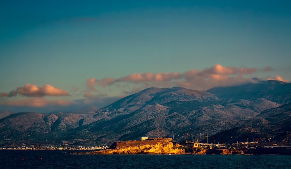 a view of a mountain range with a city in the foreground