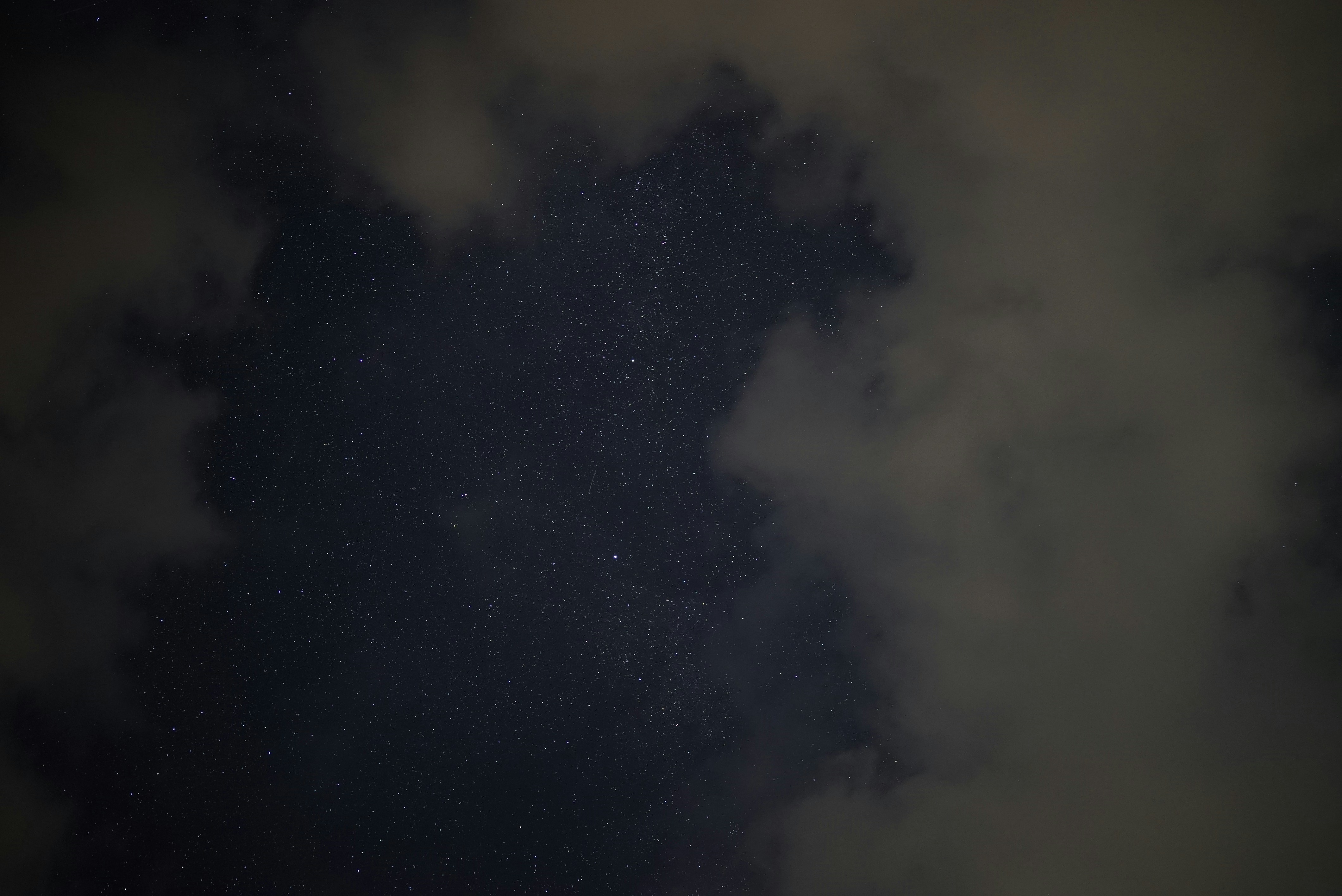 a night sky with stars and clouds