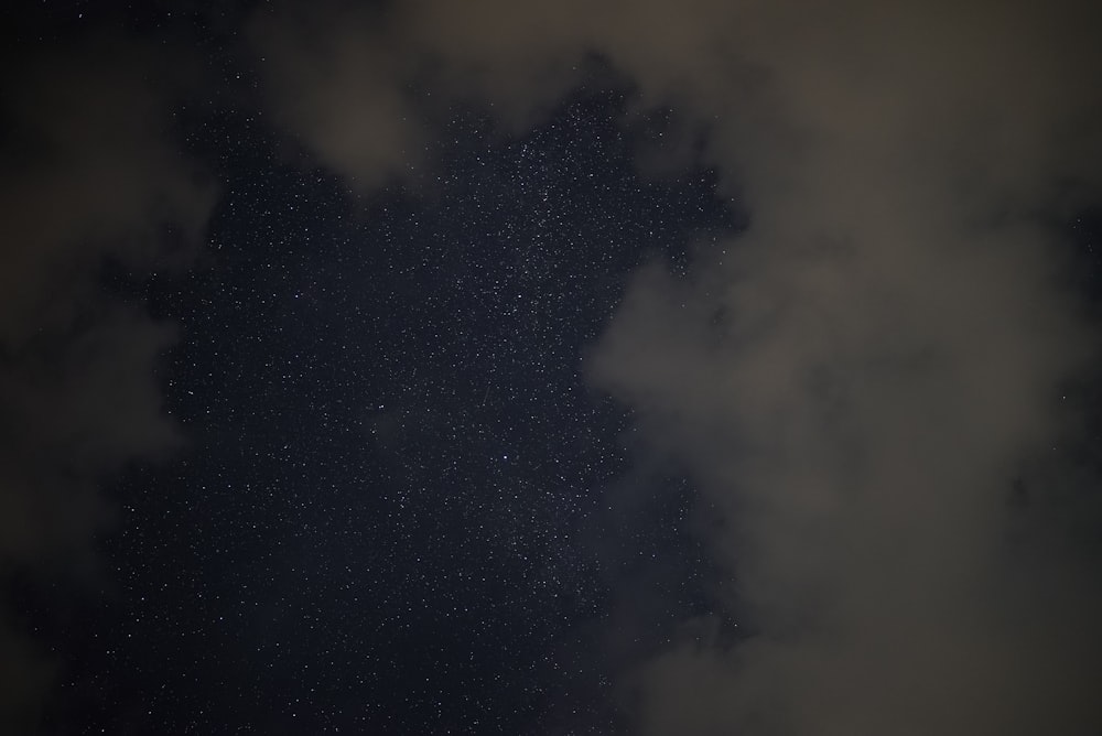 a night sky with stars and clouds