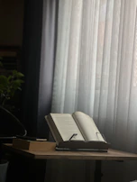 A quiet room bathed in golden afternoon light, with an open book on a wooden table.