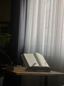 Calm and serene image of an astrologer studying ancient Vedic texts under soft golden light