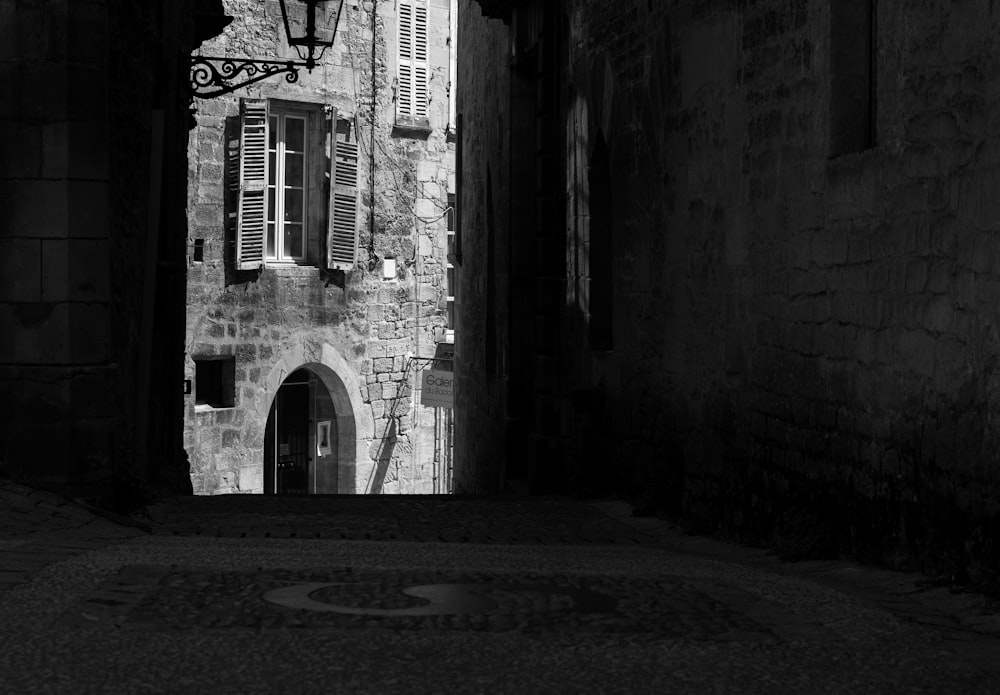 a black and white photo of an alley way