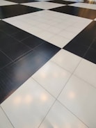 A floor composed of large black and white tiles arranged in a classic checkerboard pattern.