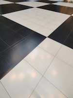 A floor composed of large black and white tiles arranged in a classic checkerboard pattern.