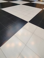 A floor composed of large black and white tiles arranged in a classic checkerboard pattern.