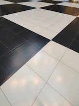 A floor composed of large black and white tiles arranged in a classic checkerboard pattern.