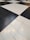 A floor composed of large black and white tiles arranged in a classic checkerboard pattern.