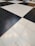 A floor composed of large black and white tiles arranged in a classic checkerboard pattern.