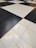 A floor composed of large black and white tiles arranged in a classic checkerboard pattern.