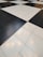 A floor composed of large black and white tiles arranged in a classic checkerboard pattern.