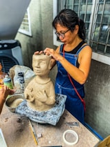 Louise Ward Morris working intently on a digital sculpture with screens and tools around.