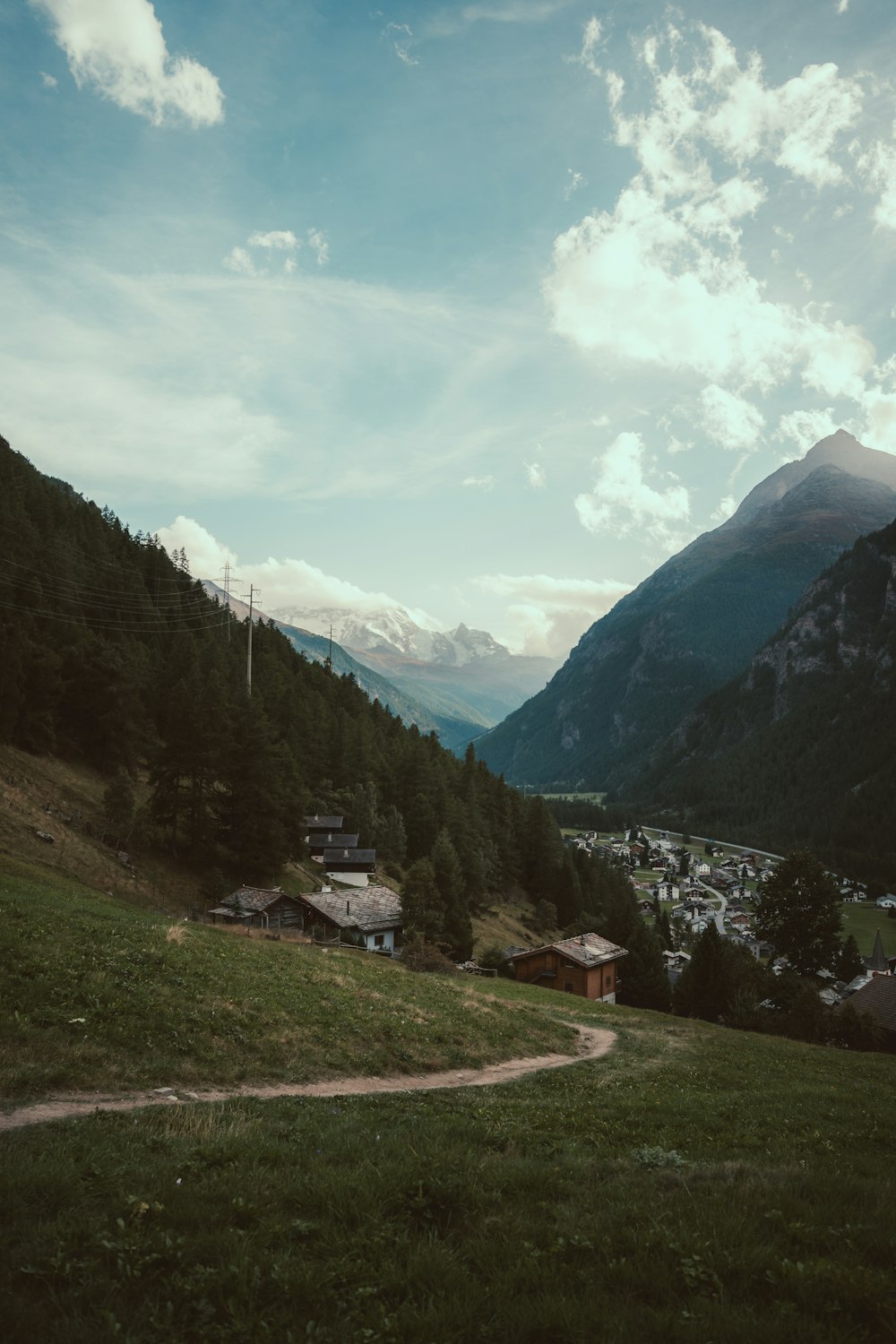 a scenic view of a small village in the mountains