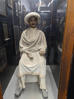 Elegant caftan displayed on a traditional Moroccan mannequin.