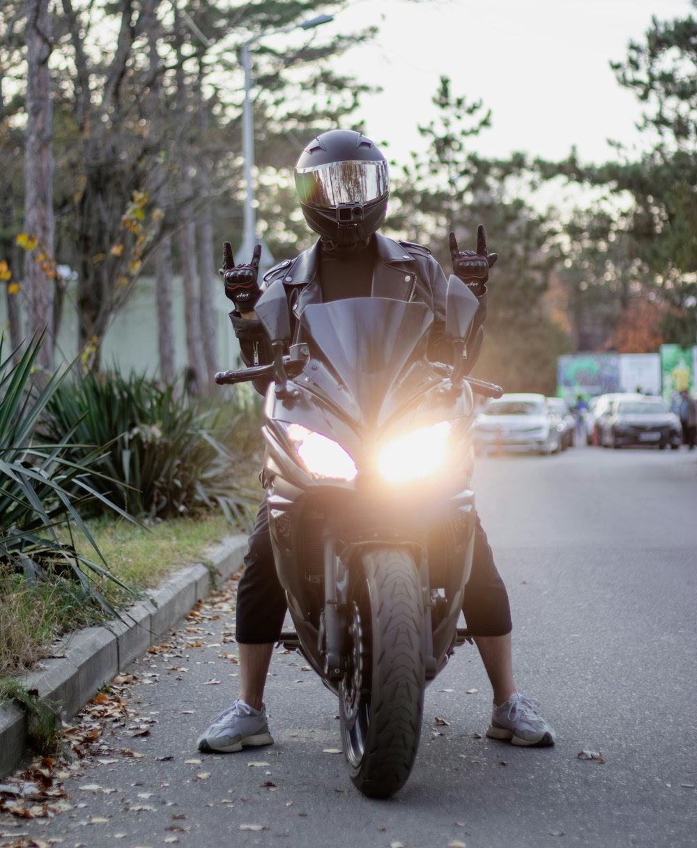 a man riding a motorcycle down a street