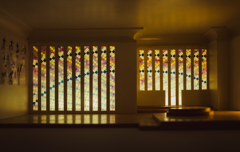 a living room with a large window covered in stained glass