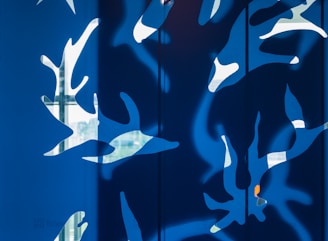 A modern canvas wall art piece showing abstract shapes in calming blues and greens.