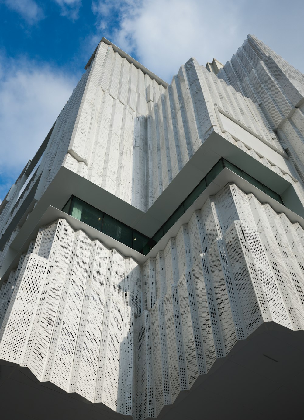 a tall white building with a sky background