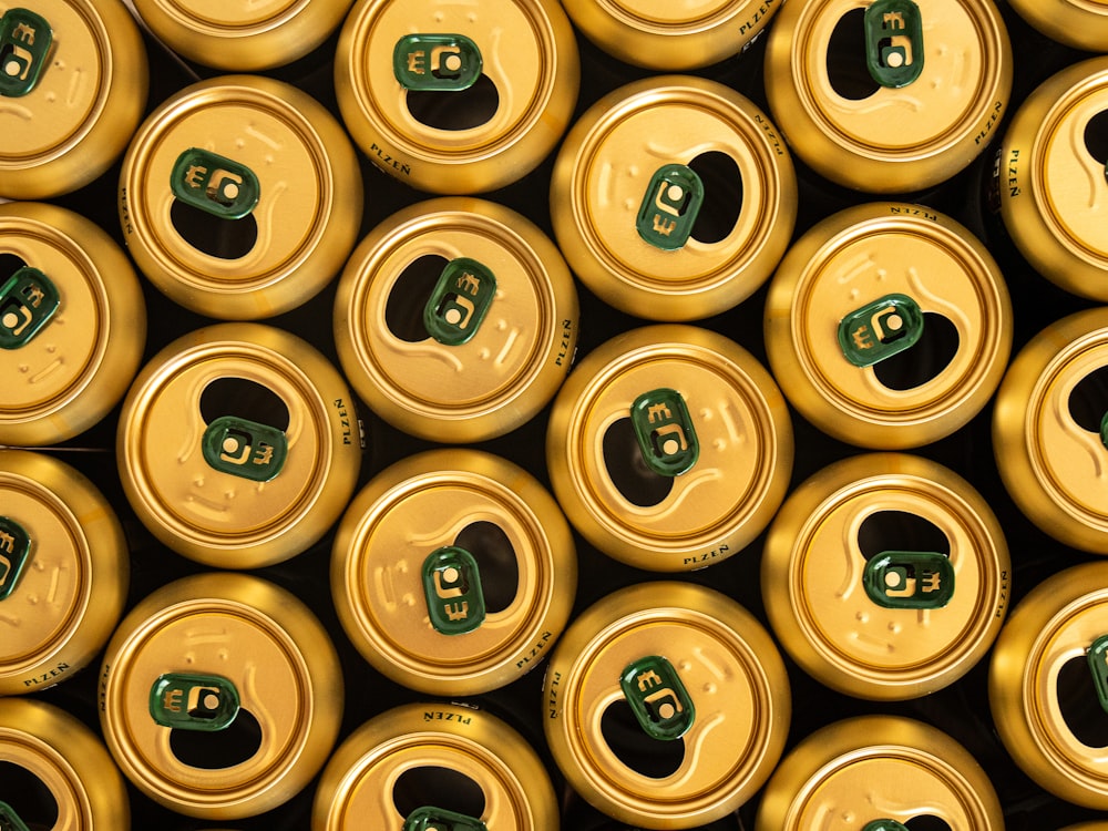 many yellow and green cans are stacked together
