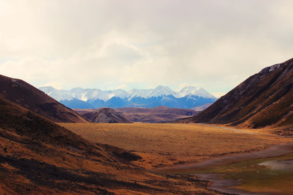 a view of a valley with mountains in the background