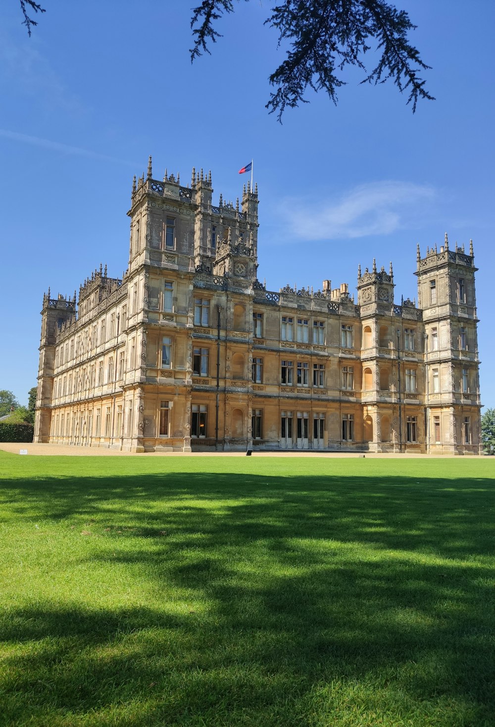 a large building sitting on top of a lush green field