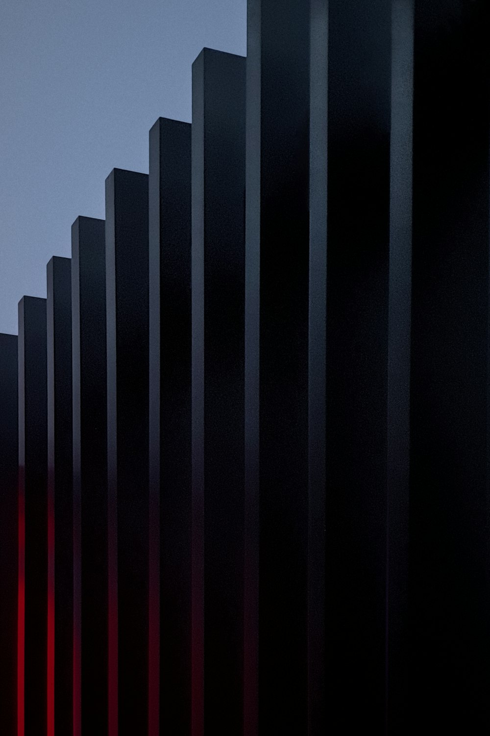 a row of black and red lines against a blue sky