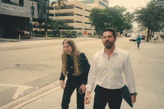 A mentor and mentee walking together along a city sidewalk in Hamilton.