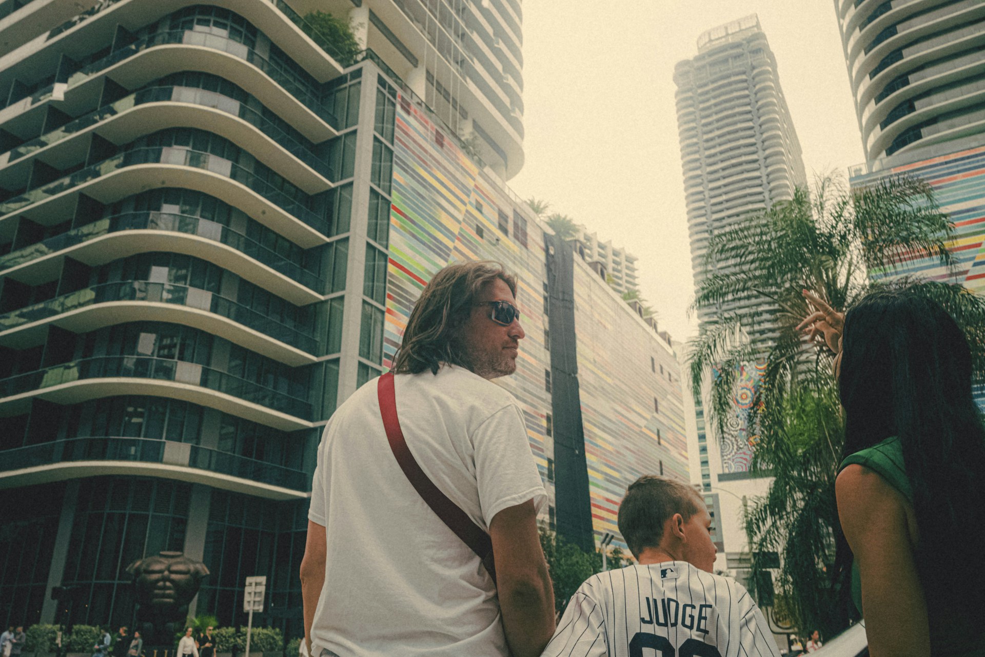 A friendly local guide sharing stories with a small group against the backdrop of Shenzhen's modern skyline.