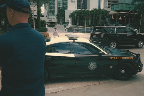 a man standing in front of a police car