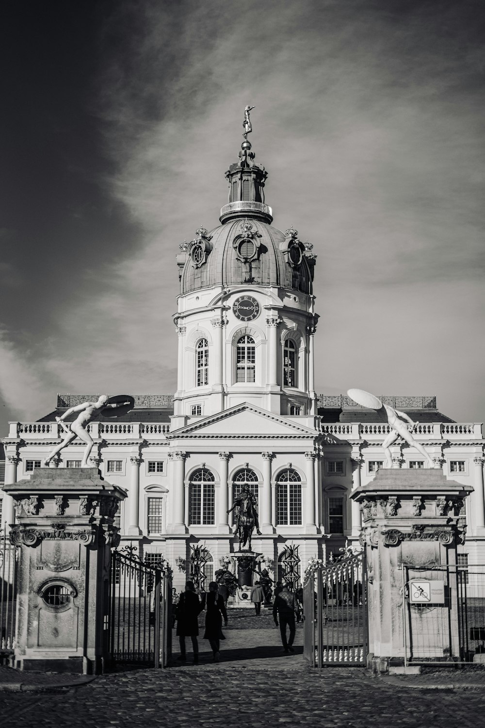 a black and white photo of a building with a clock tower