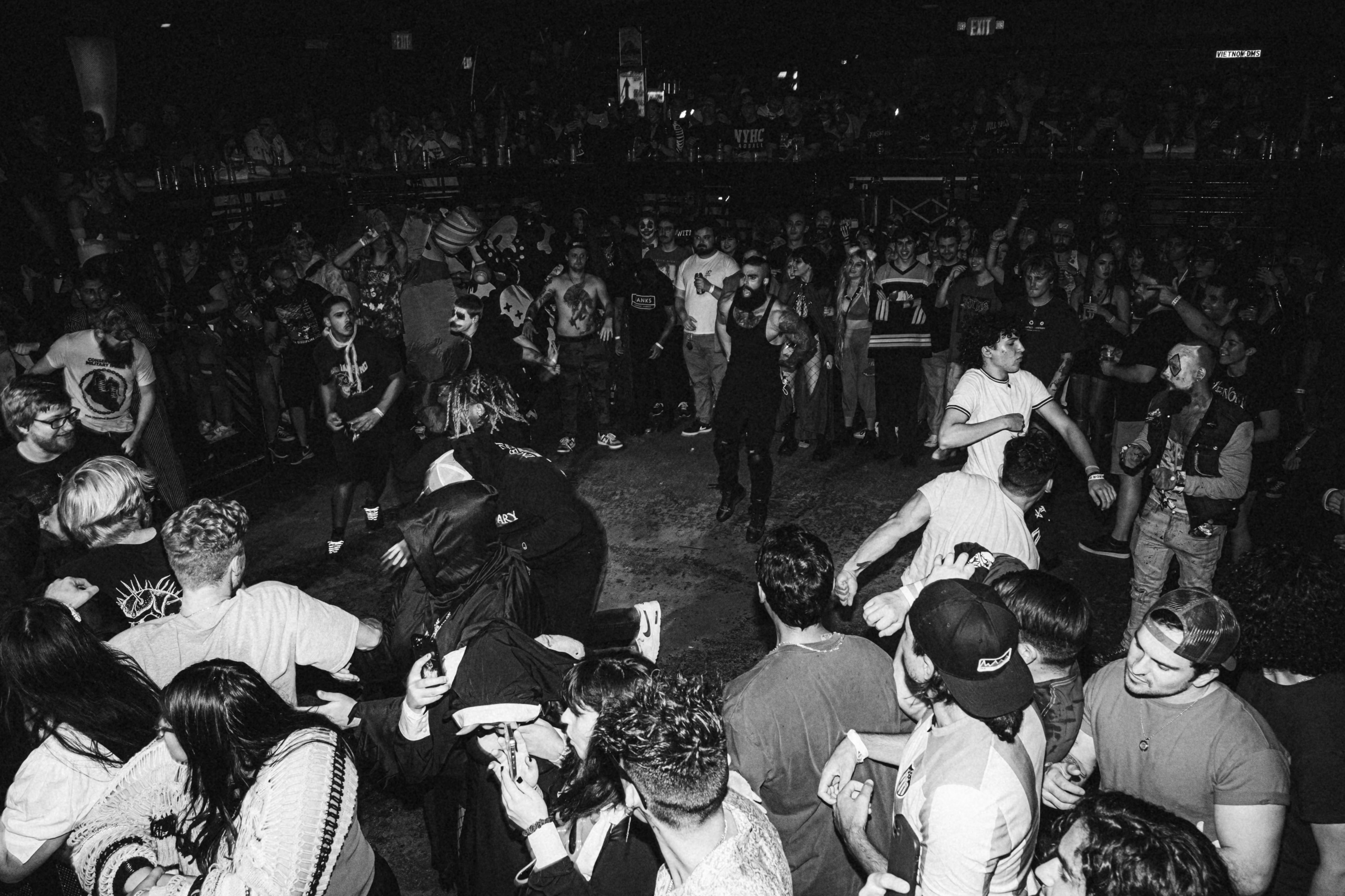 a crowd of people standing around each other