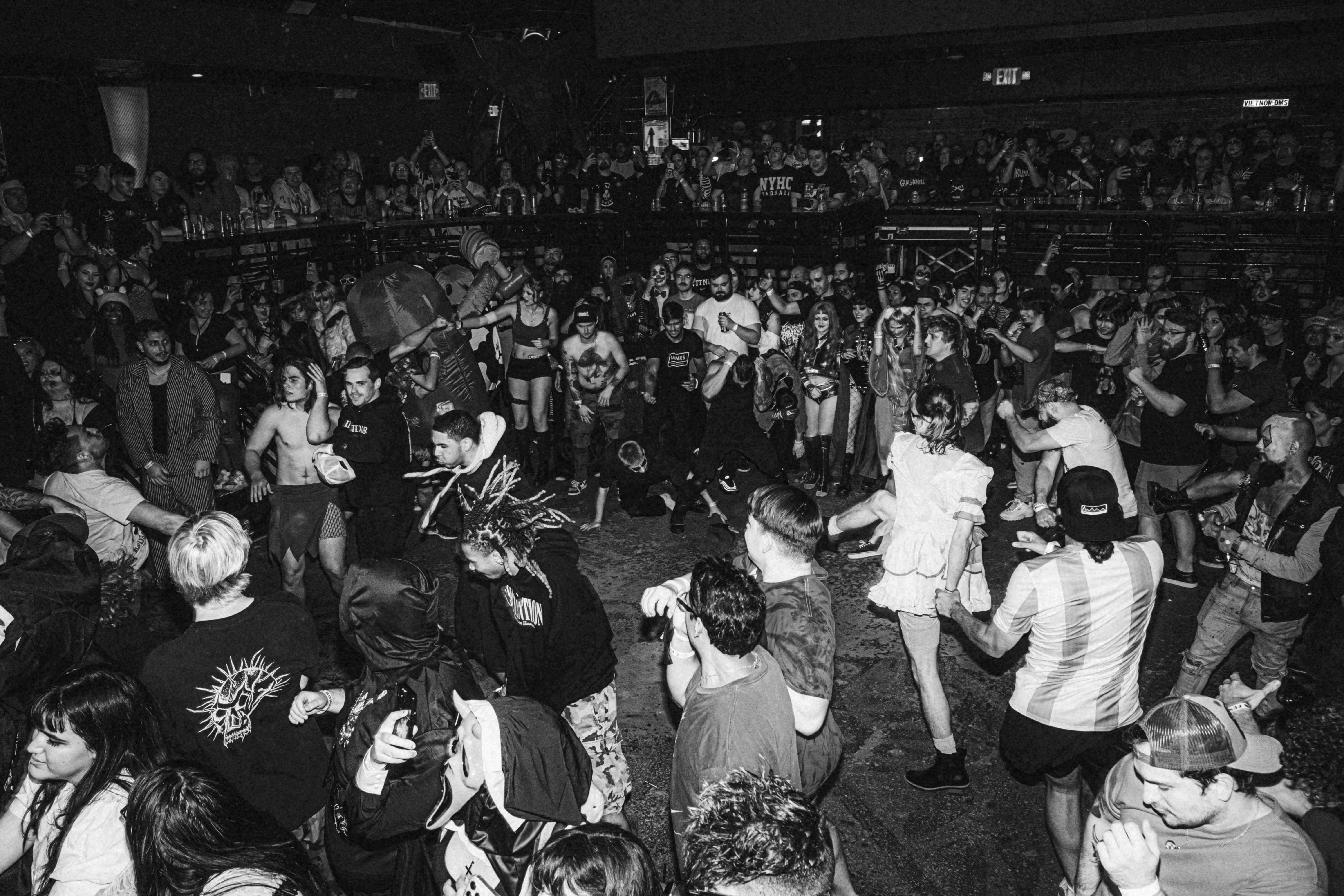 a crowd of people standing around each other