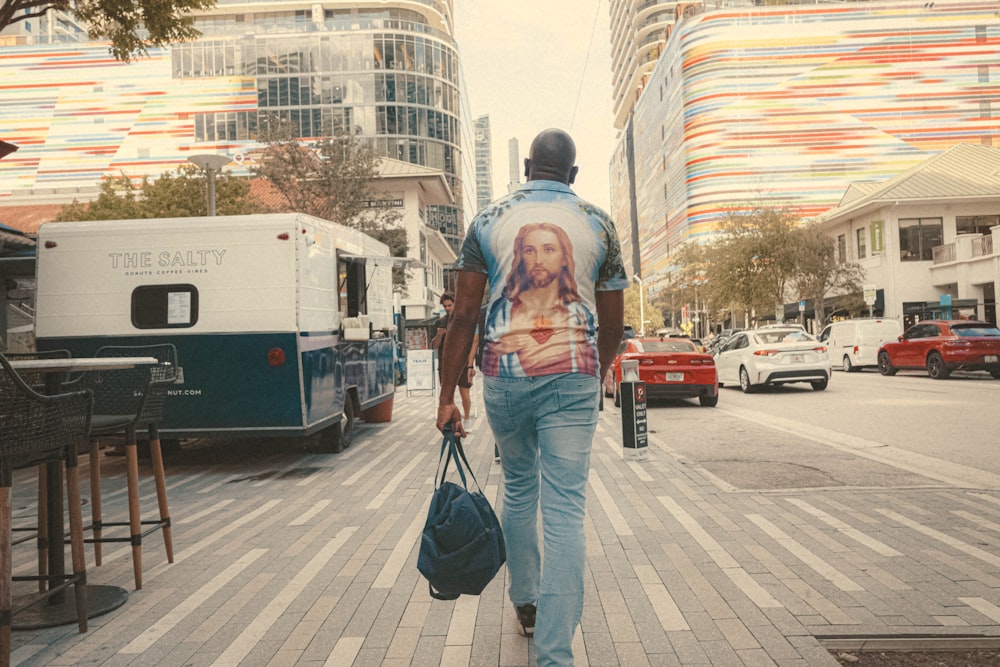 a man walking down a street carrying a bag