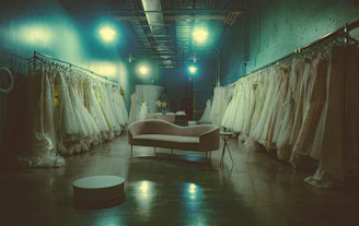 A warm, inviting bridal studio with Gimena Montalvo fitting a bride in a delicate wedding dress.