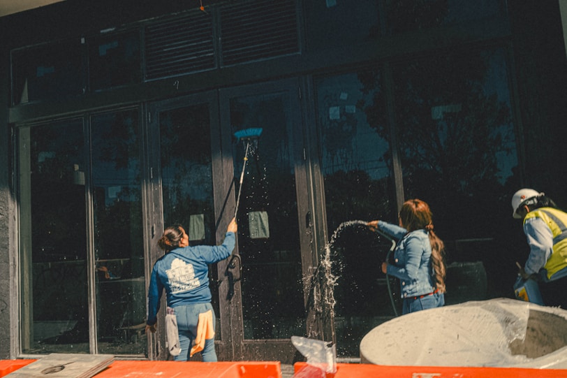 Team members sanitizing a public building's common areas with care